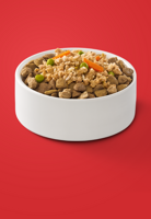 Fresh Purina ONE dog food entrée placed over dry kibble in a white bowl.