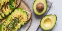 sliced avocado and avocado toast on table