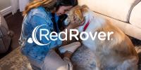 Woman snuggling dog with white Red Rover logo