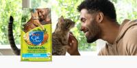 Man smiling and petting gray cat