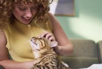 woman looking down at cat that is looking up at her