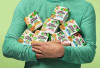 a man in green striped shirt holding several packages of beneful freshly prepared dog food