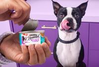 Two hands holding and stacking can of Beneful in gravy and loaf.