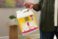 Human holding Tidy Cats Lightweight litter with their pinky finger.