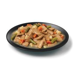 Purina Pro Plan Complete Essentials beef and vegetables wet dog food in a dish