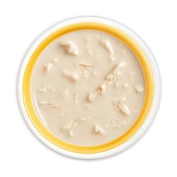 Friskies lil' soups with chicken in a velvety tuna broth flavored cat food topper in bowl"