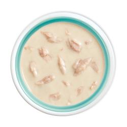 alt= "Friskies lil' soups with tuna in a velvety tuna broth flavored cat food topper in bowl