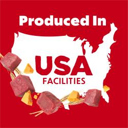 Raw beef, cheese, and wheat surround a US map outline with text: Produced In USA Facilities.