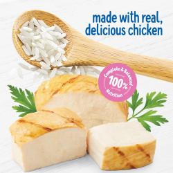 Slices of grilled chicken, green garnish, and a wodden spoon with rice sit on a white textured background. Text reads Made With real Delicious Chicken. A pink badge says 100% Completed and Balanced Nutrition.