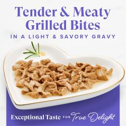 Fancy Feast Grilled Seafood Feast wet cat food tender meaty seafood bites in light savory gravy on a heart-shaped plate.