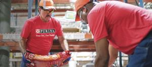 men loading dog food