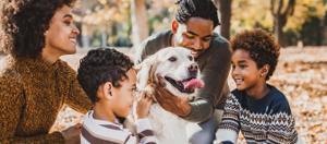 family hugging their dog
