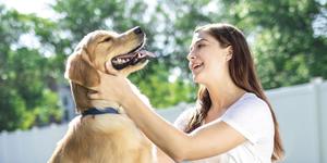 Woman petting her happy dog