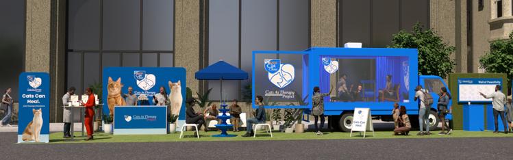 An event showcasing a Cats As Therapy truck and attendees interacting with different stations