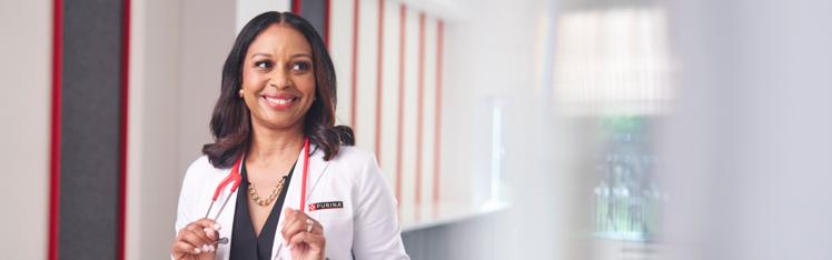 Dr. Callie posing with a red stethoscope