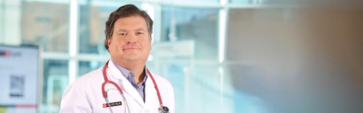Dr.Kurt posing in a lab coat