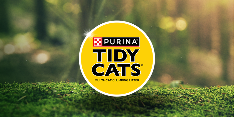 Purina Tidy Cats logo on a mossy background.