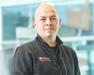 Dr. Miles in black jacket with Purina logo