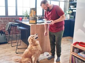 man giving food to his dog