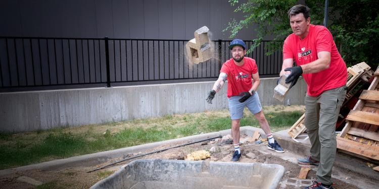 men working toss bricks