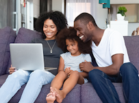 family of three on the couch enjoying Purina Farms weekly virtual events