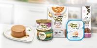 Fancy Feast packaging lineup, next to pate cat food on plate