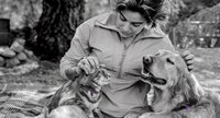 Woman petting a cat and a dog