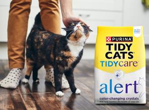 person with cat and Tidy Care Alert packaging