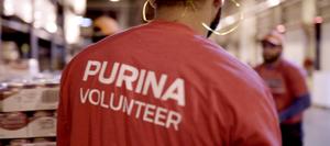 man with a Purina volunteer shirt