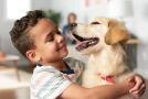 boy hugging dog
