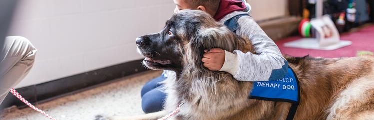 child hugging dog