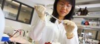 A scientist conducting research, injecting a substance into a tube