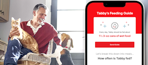 Man sitting chair with cat and dog and a phone with the Pet Feeding Guide app displayed