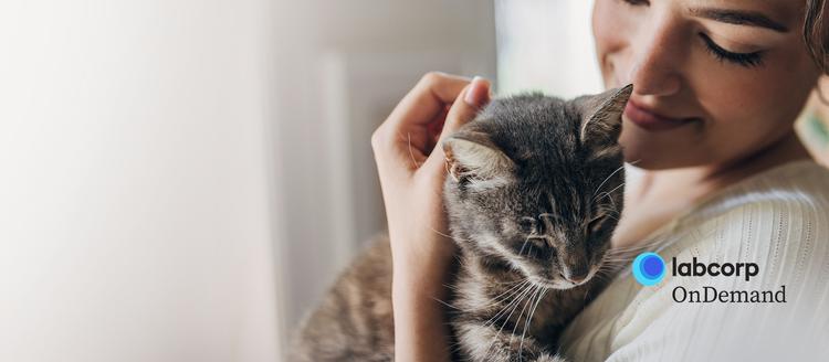 A person holding a cat