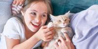 young girl playing with a small cat