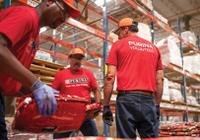 Purina employees working together in the manufacturing process