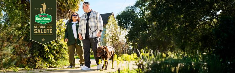 man and woman walking service dog