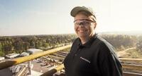 A Purina employee wearing safety goggles and a hat