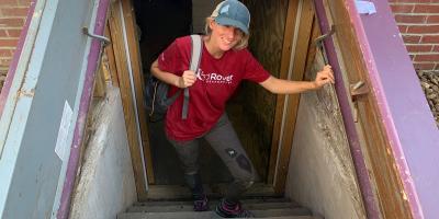 The woman is coming out of the shelter