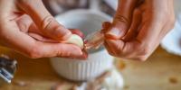 person peeling garlic