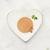 Fancy Feast Gourmet Naturals wet kitten food plated on a heart-shaped dish