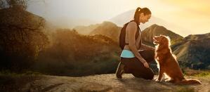 Woman and dog in mountains