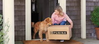 A woman and a dog with a box from Pro Plan Vet Direct home delivery
