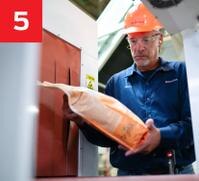 man with hard hat inspecting package