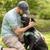 person interacting with black labrador retriever service dog