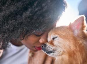 woman touching foreheads with her dog