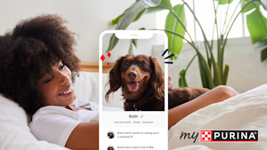 mypurina app on an iPhone with a woman and her dog on the couch in the background