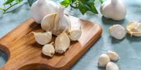 garlic bulbs displayed on cutting board