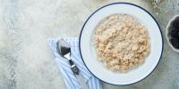 bowl of oatmeal and spoon on table