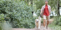 A man walks with a dog
